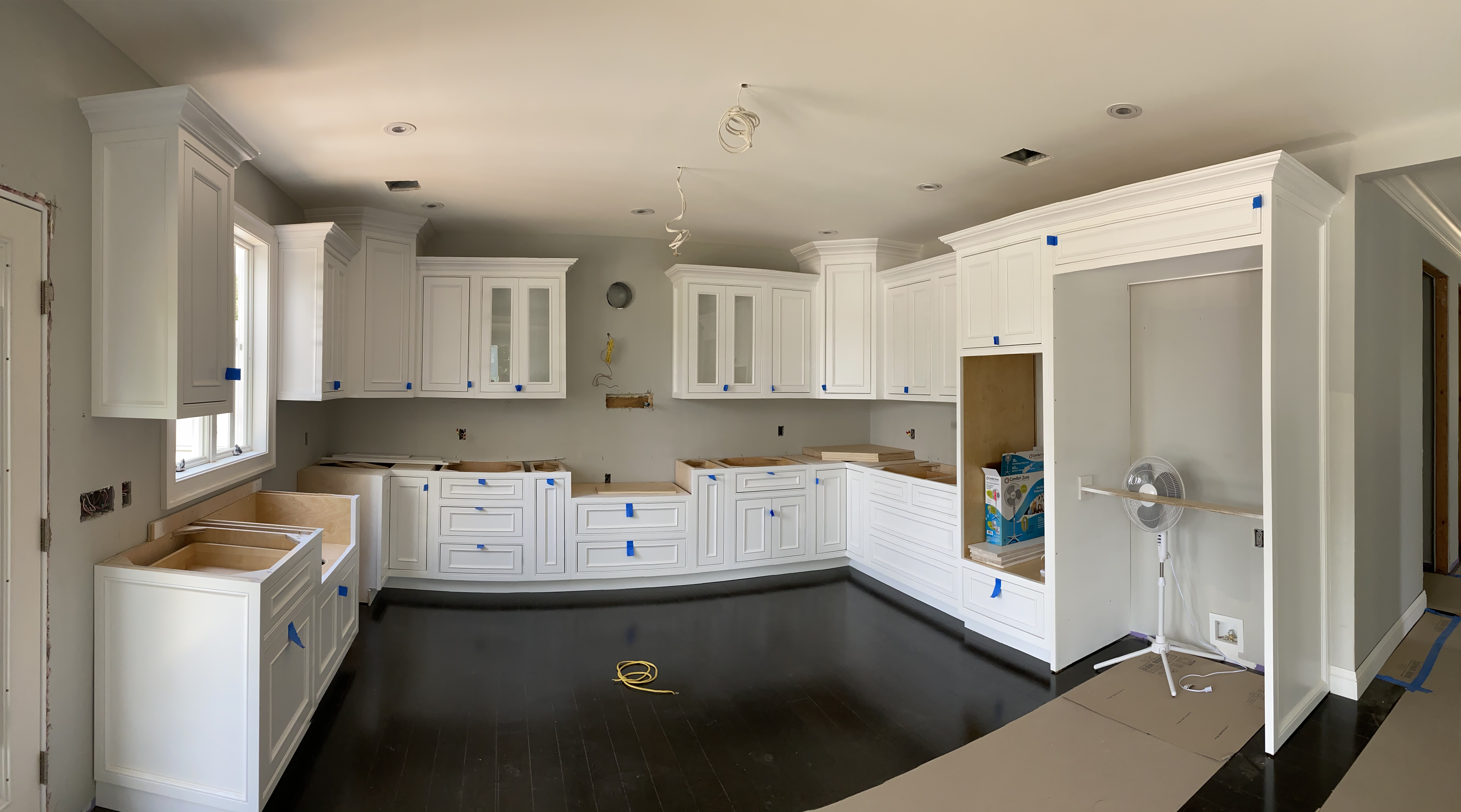 White kitchen with wooden floor